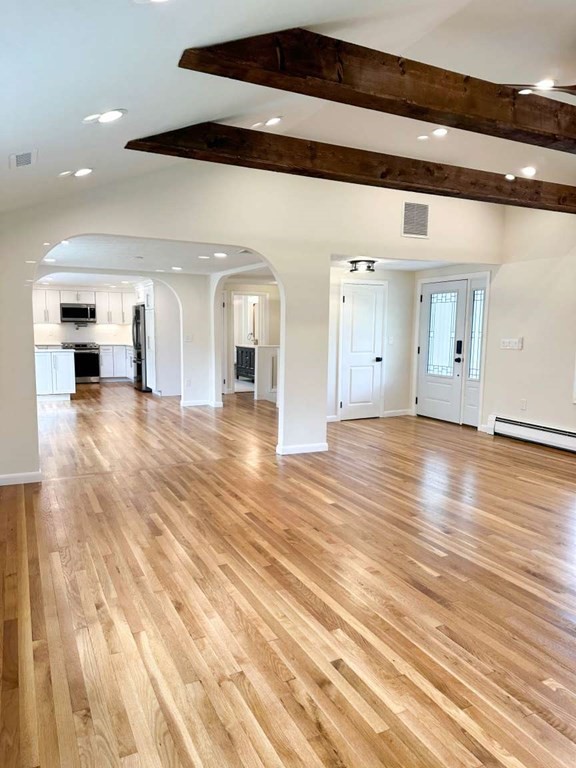 123 Burbank Road Sutton, MA 01590 - Photo 4 of 20 a view of a hall with wooden floor and a large window