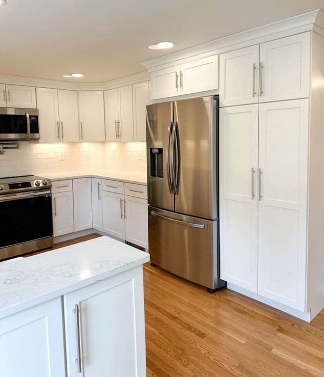 123 Burbank Road Sutton, MA 01590 - Photo 7 of 20 a kitchen with granite countertop a refrigerator a sink and white cabinets