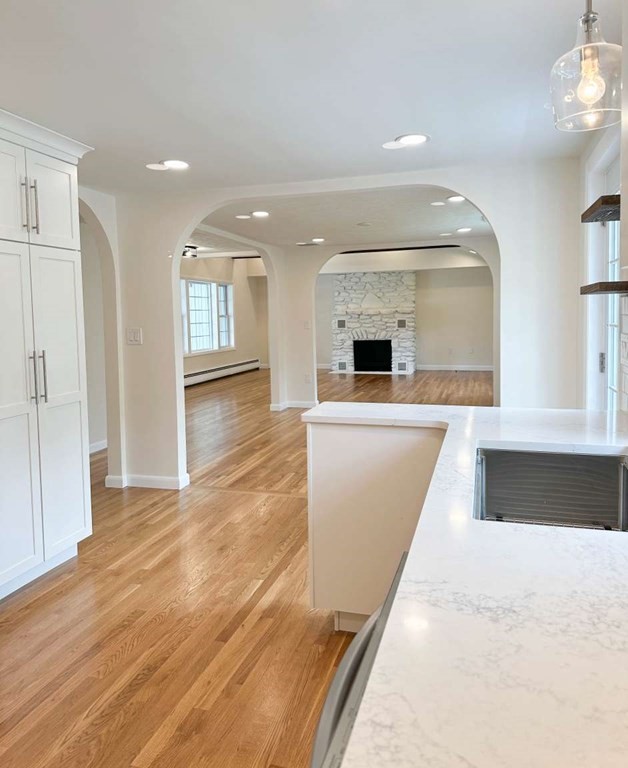 123 Burbank Road Sutton, MA 01590 - Photo 10 of 20 a view of a kitchen with a sink and dishwasher with wooden floor