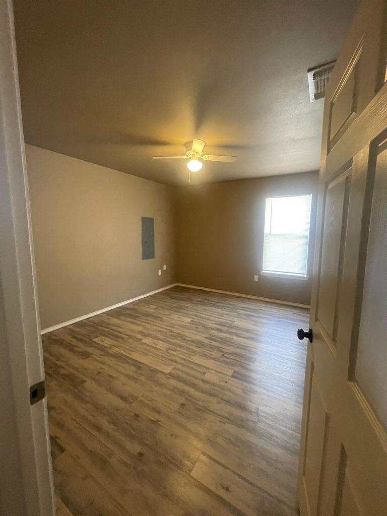 3421 East Bates Street Lubbock, TX 79403 - Photo 3 of 8 a view of empty room with window and wooden floor