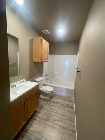a bathroom with a double vanity sink toilet and mirror