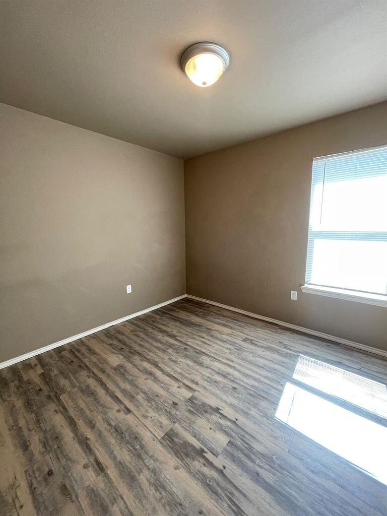 3421 East Bates Street Lubbock, TX 79403 - Photo 5 of 8 a view of empty room with wooden floor