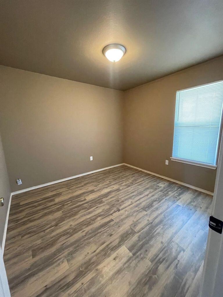 3421 East Bates Street Lubbock, TX 79403 - Photo 6 of 8 a view of empty room with wooden floor