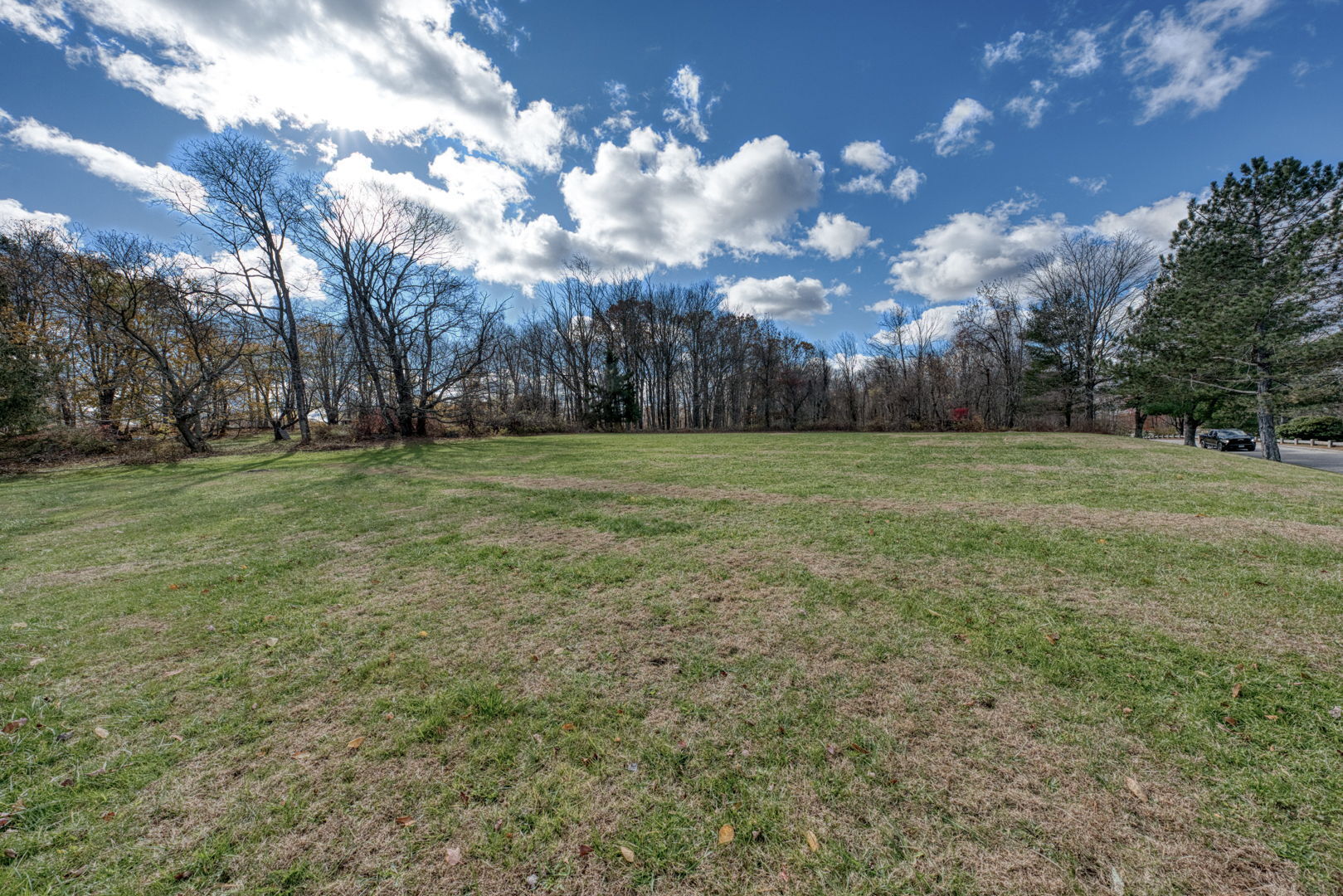 287 Maple Road Mansfield, CT 06268 - Photo 34 of 38 a view of a grassy field with trees in the background