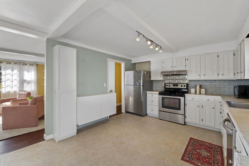 6 True Road Salisbury, MA 01952 - Photo 11 of 40 a kitchen with stainless steel appliances kitchen island granite countertop a refrigerator and a stove top oven