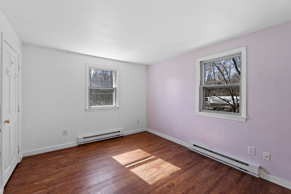 6 True Road Salisbury, MA 01952 - Photo 18 of 40 a view of an empty room with window and wooden floor