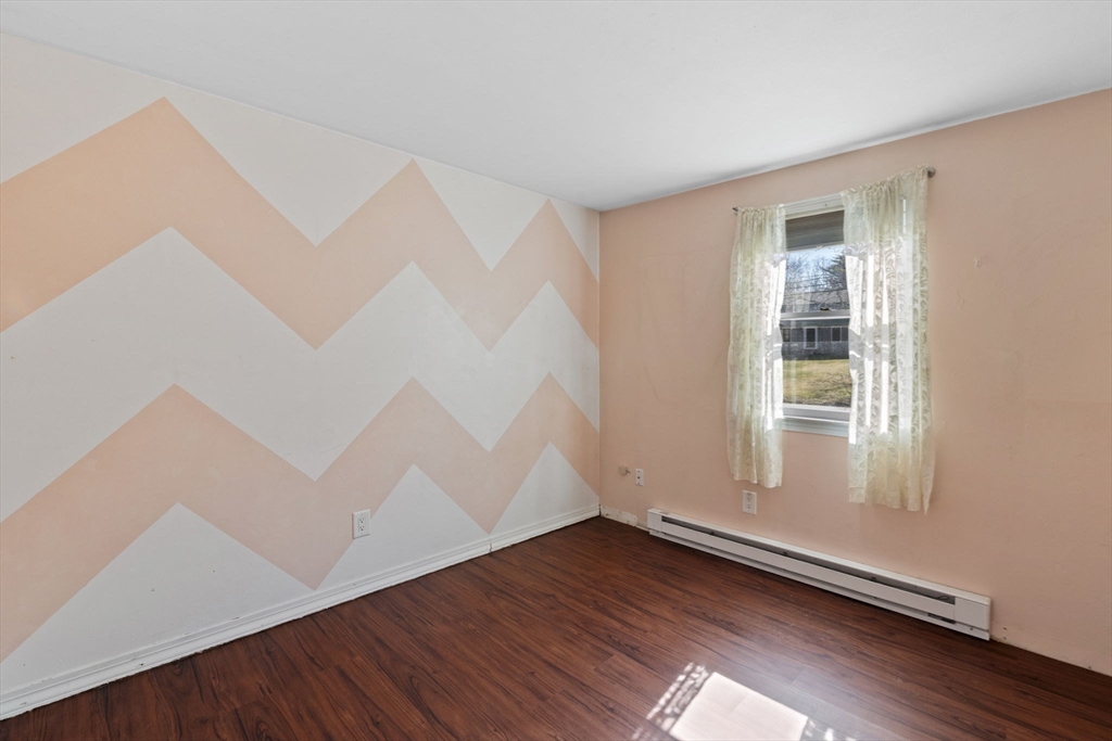 6 True Road Salisbury, MA 01952 - Photo 19 of 40 an empty room with wooden floor and windows