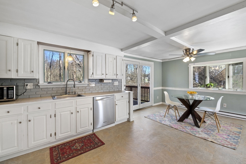 6 True Road Salisbury, MA 01952 - Photo 10 of 40 a open kitchen with stainless steel appliances granite countertop a stove a sink dishwasher and white cabinets with wooden floor