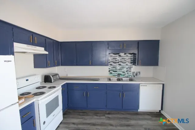 a kitchen with a cabinets and wooden floor
