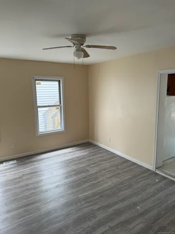 a view of a room with wooden floor and shoes