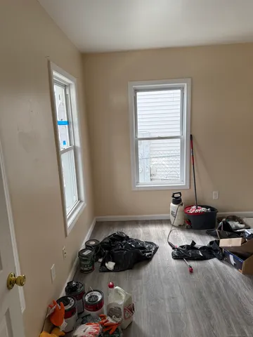 a kitchen with a refrigerator and white cabinets