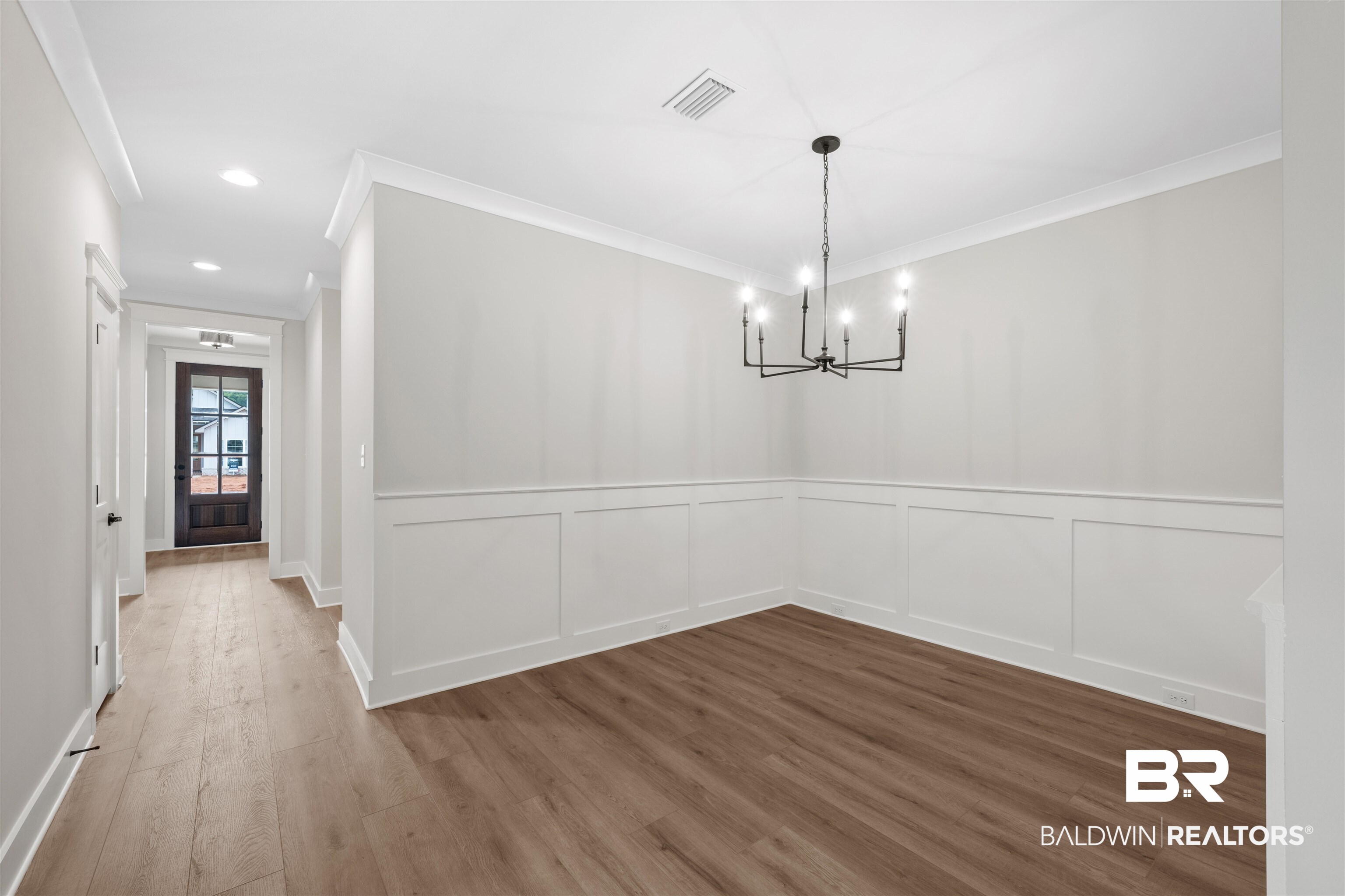 27494 Patch Pl Loop Daphne, AL 36526 - Photo 7 of 26 Interior room featuring wood-finish flooring, white wainscoting, crown molding, a modern black chandelier, and recessed lighting