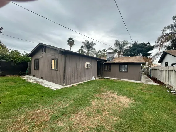 a view of backyard of house with green space