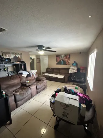 a living room with lots of furniture and a wooden floor