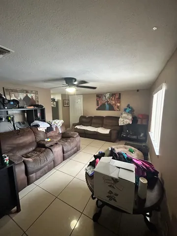a living room with lots of furniture and a wooden floor