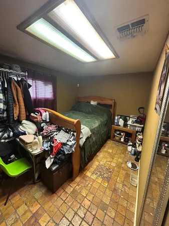 a room with stainless steel appliances kitchen island granite countertop furniture and a view of kitchen