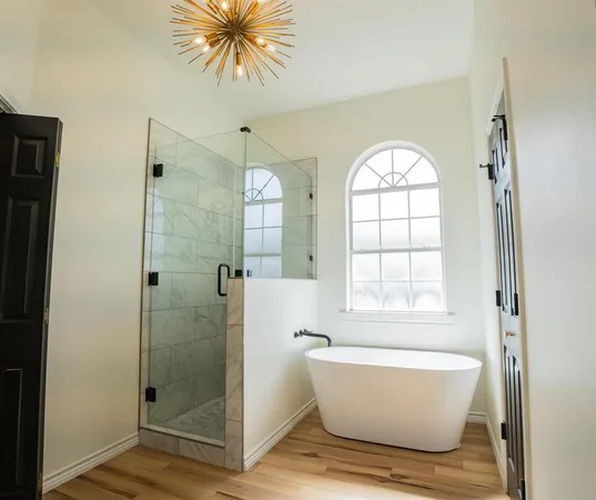 a bathroom with a bathtub and shower