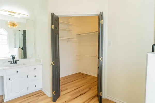 a view of bathroom with a sink a mirror and a shower
