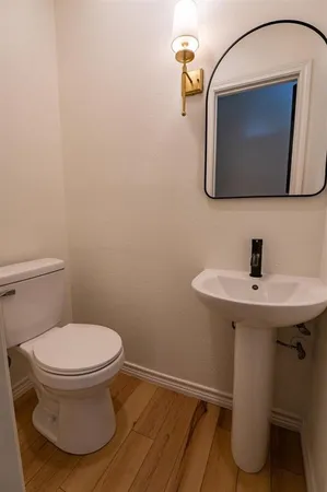 a bathroom with a sink toilet and mirror