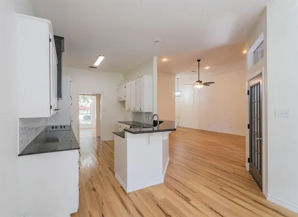 a kitchen with granite countertop a stove and a refrigerator