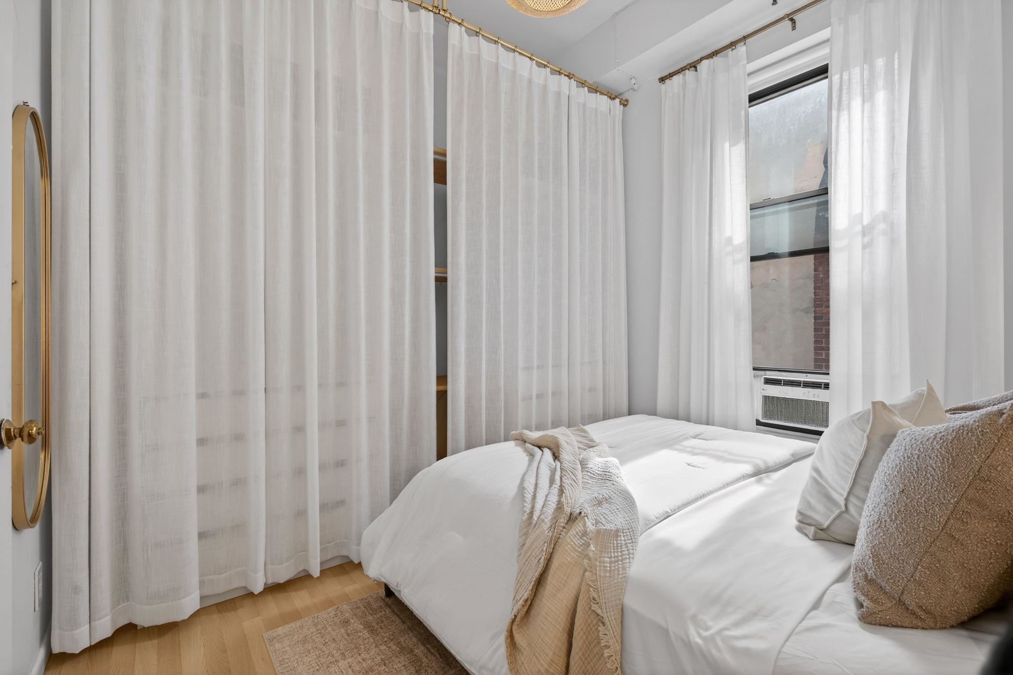 723 Washington Street, Unit 5 Hoboken, NJ 07030 - Photo 12 of 25 a bed sitting in a bedroom next to a window