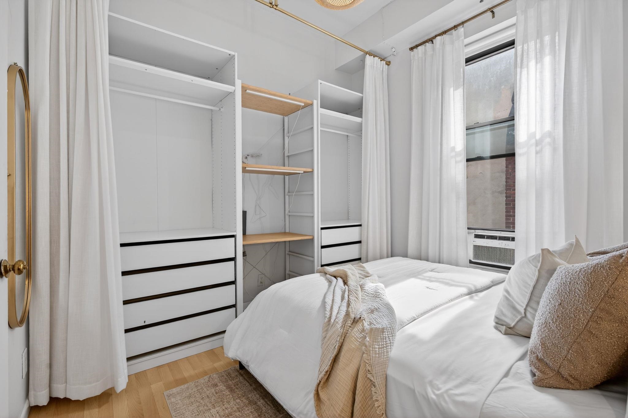 723 Washington Street, Unit 5 Hoboken, NJ 07030 - Photo 13 of 25 a bedroom with a bed and a walk in closet