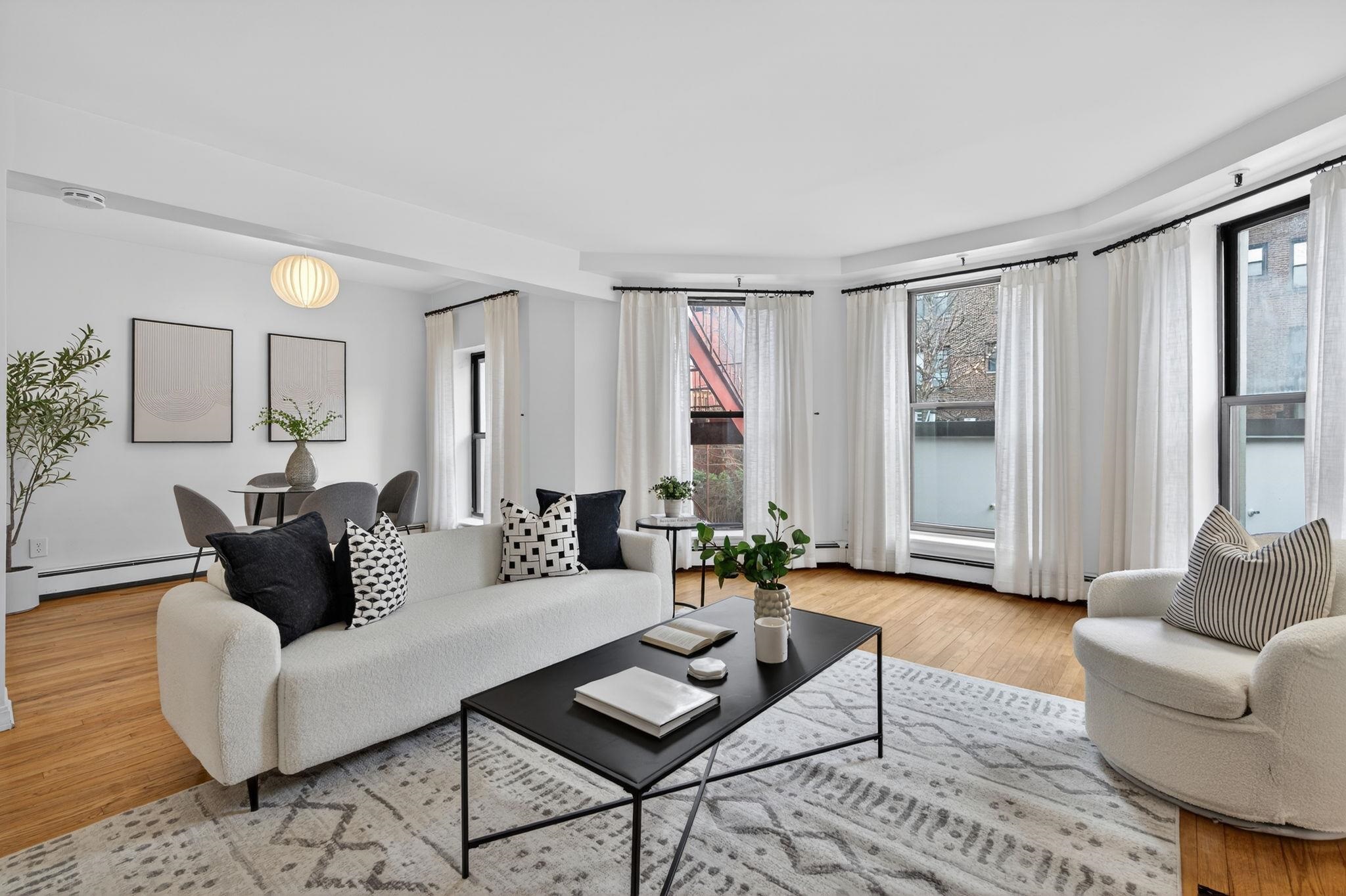 723 Washington Street, Unit 5 Hoboken, NJ 07030 - Photo 5 of 25 a living room with furniture and a large window