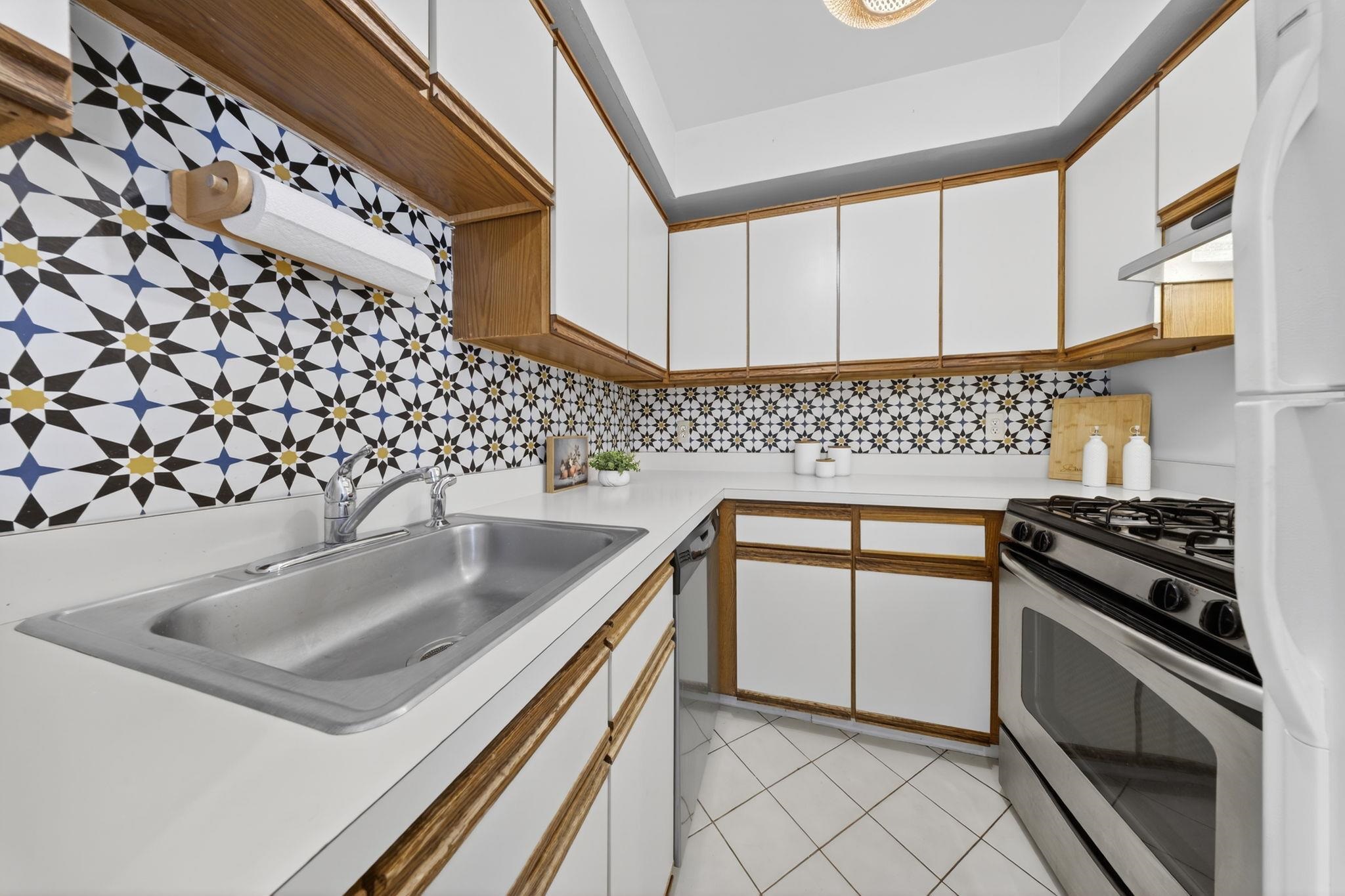 723 Washington Street, Unit 5 Hoboken, NJ 07030 - Photo 9 of 25 a kitchen with granite countertop a sink stove and cabinets