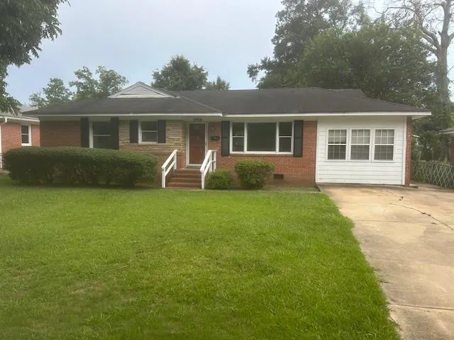 a front view of house with yard and green space