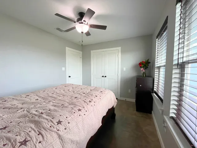 a bedroom with a bed and a chandelier