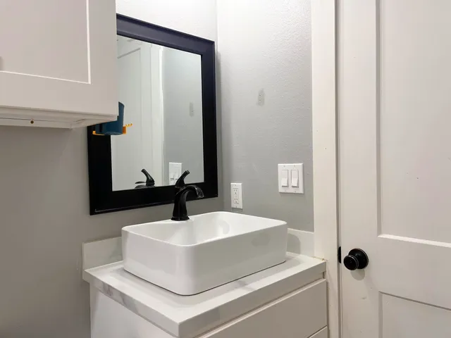 a bathroom with a sink and a mirror