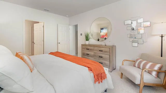 a bedroom with a bed and a dresser