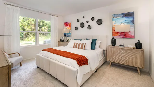 a bedroom with bed and a window