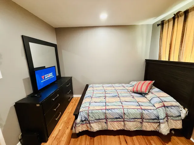 a bedroom with a bed and a flat screen tv