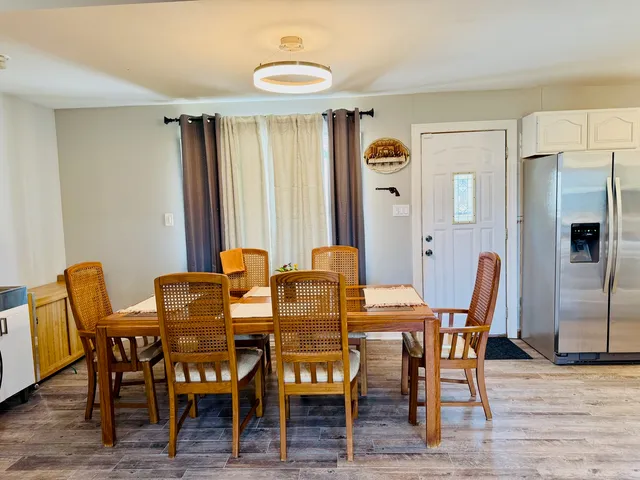 a view of a dining room with furniture and wooden floor