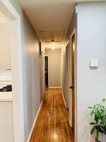 a view of a hallway with wooden floor