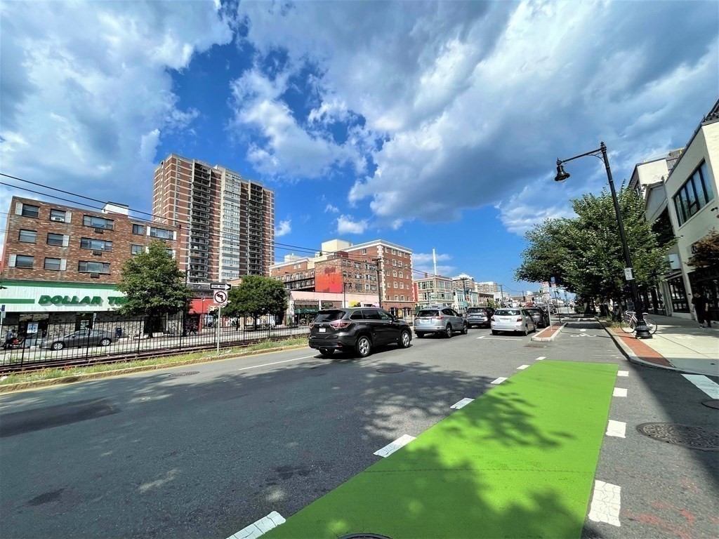 a view of a city street lined with tall buildings