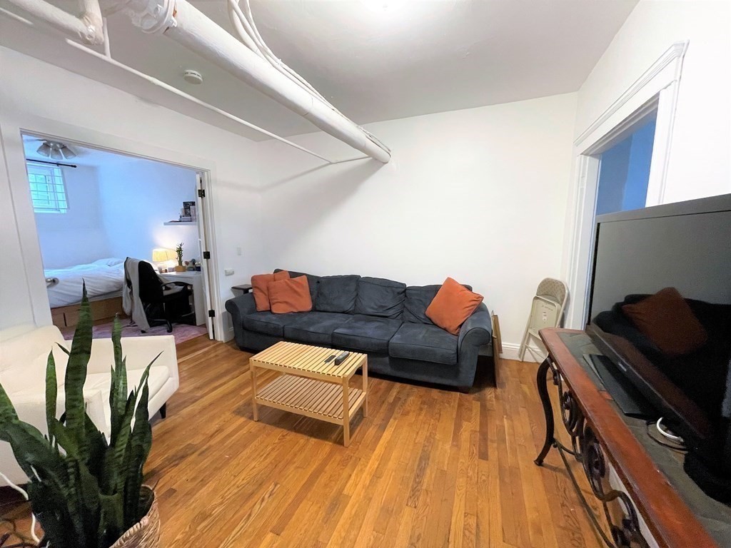 33 Winslow Road, Unit B Brookline, MA 02446 - Photo 11 of 14 a living room with furniture and a flat screen tv