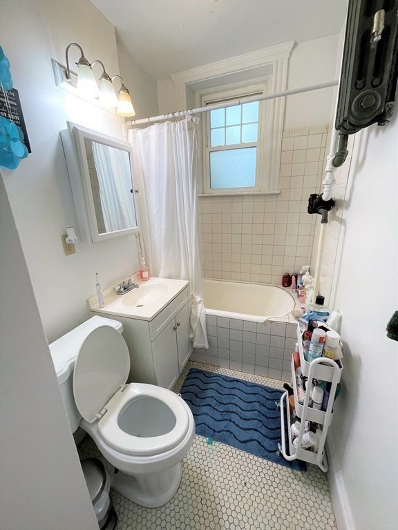 33 Winslow Road, Unit B Brookline, MA 02446 - Photo 12 of 14 a bathroom with a sink toilet and shower
