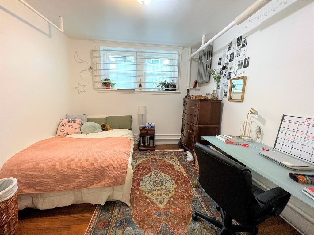 33 Winslow Road, Unit B Brookline, MA 02446 - Photo 6 of 14 a bedroom with a bed and a table in it