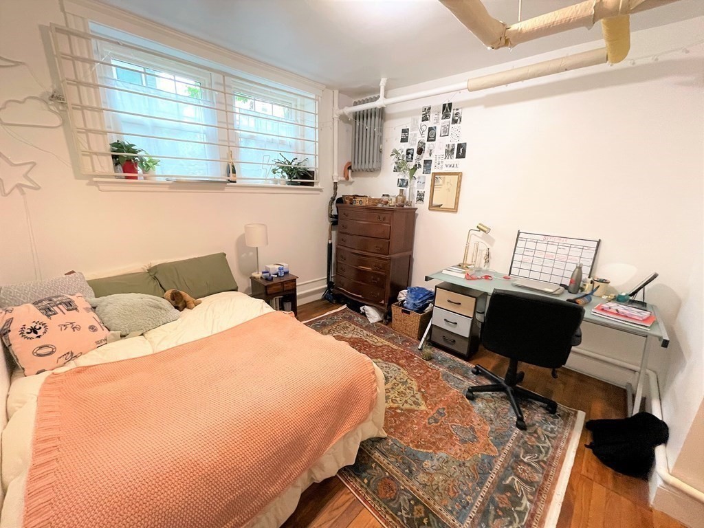 33 Winslow Road, Unit B Brookline, MA 02446 - Photo 7 of 14 a bedroom with a bed and wooden floor