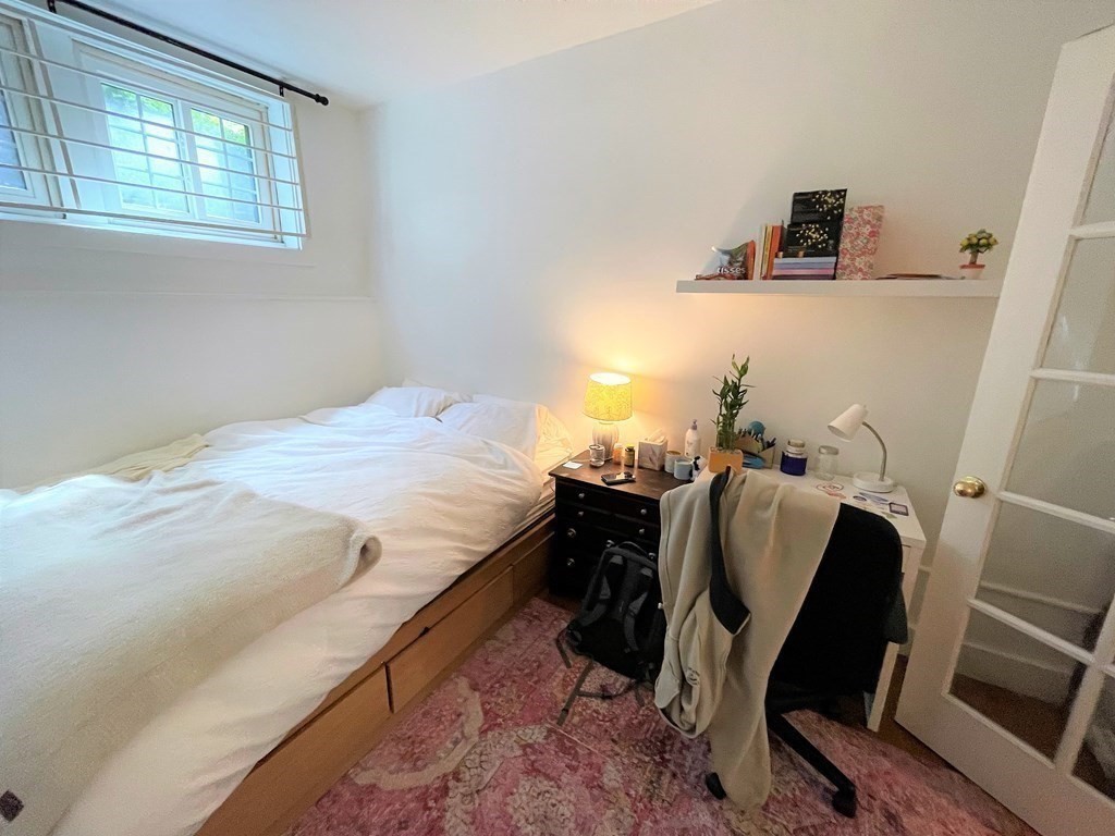 33 Winslow Road, Unit B Brookline, MA 02446 - Photo 8 of 14 a bed sitting in a bedroom next to a window