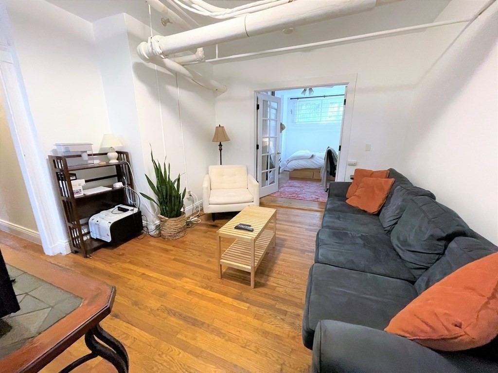 33 Winslow Road, Unit B Brookline, MA 02446 - Photo 10 of 14 a living room with furniture and a window
