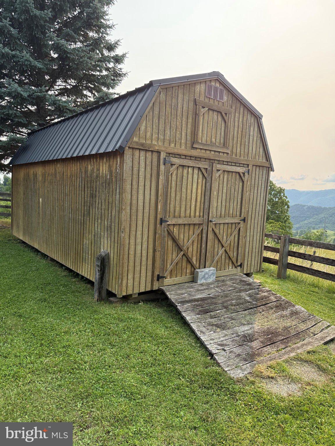 1492 Dice Warner Road Circleville, WV 26804 - Photo 28 of 36 Rustic barn shed in serene landscape.