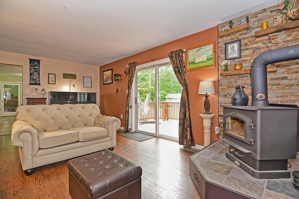173 Webster Street Douglas, MA 01516 - Photo 11 of 42 a living room with furniture a flat screen tv and a large window