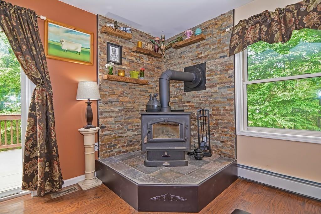 173 Webster Street Douglas, MA 01516 - Photo 12 of 42 a living room with fireplace furniture and a window