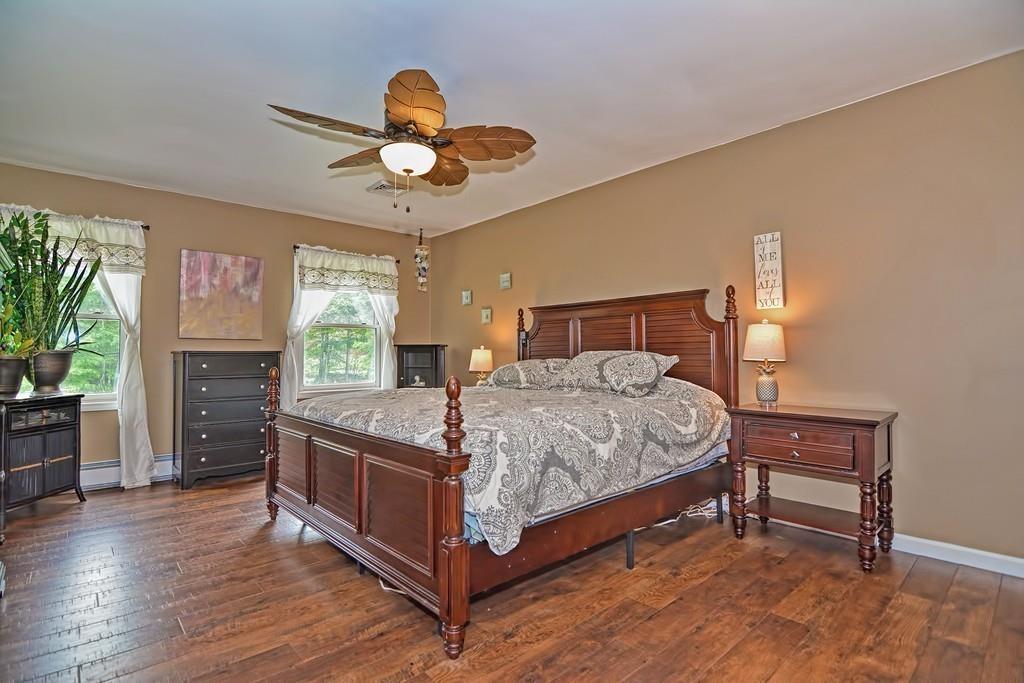 173 Webster Street Douglas, MA 01516 - Photo 22 of 42 a bedroom with a bed chandelier and a window