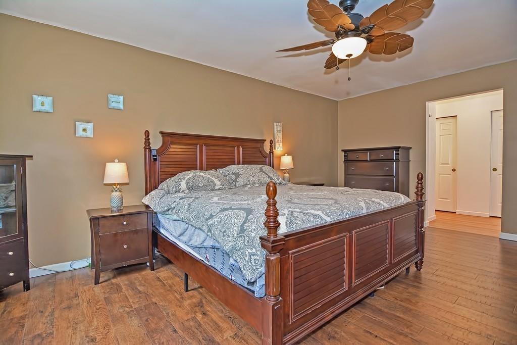 173 Webster Street Douglas, MA 01516 - Photo 23 of 42 a bedroom with a bed and a chandelier