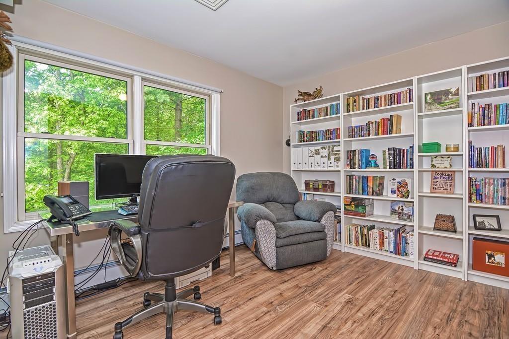 173 Webster Street Douglas, MA 01516 - Photo 32 of 42 a living room with furniture and a book shelf