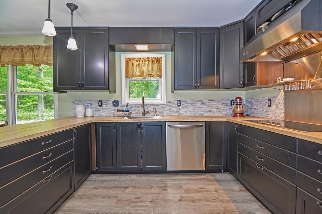 173 Webster Street Douglas, MA 01516 - Photo 5 of 42 a kitchen with a sink window and cabinets